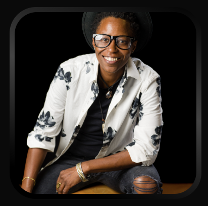 Portrait of comedian Domo Cann smiling at the camera.
